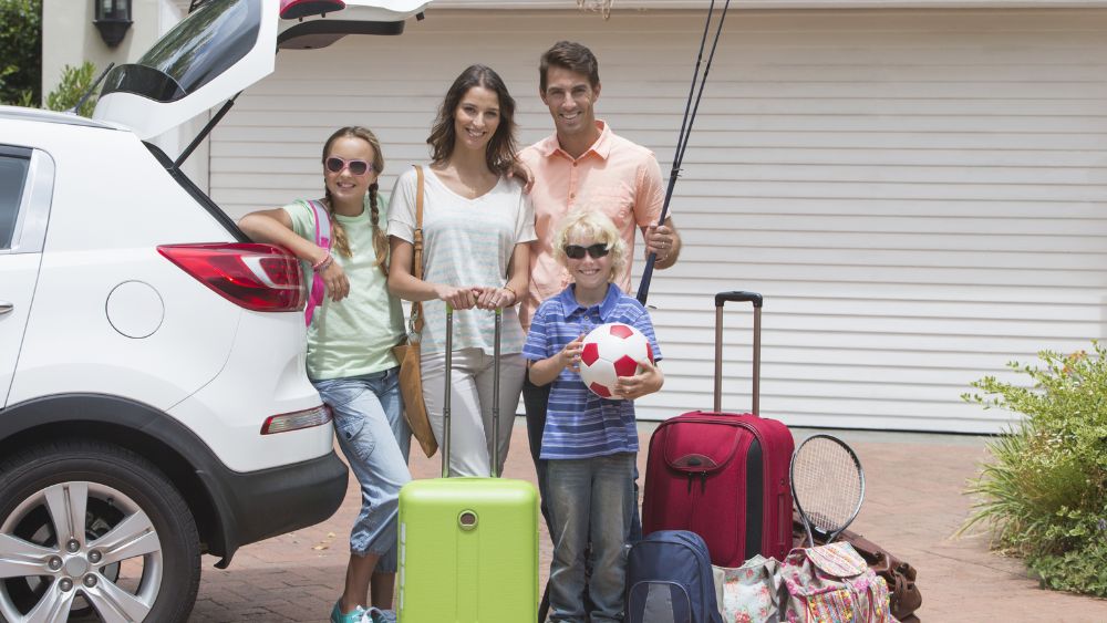 Family With Luggage Beside An SUV - Car Rentel Blog